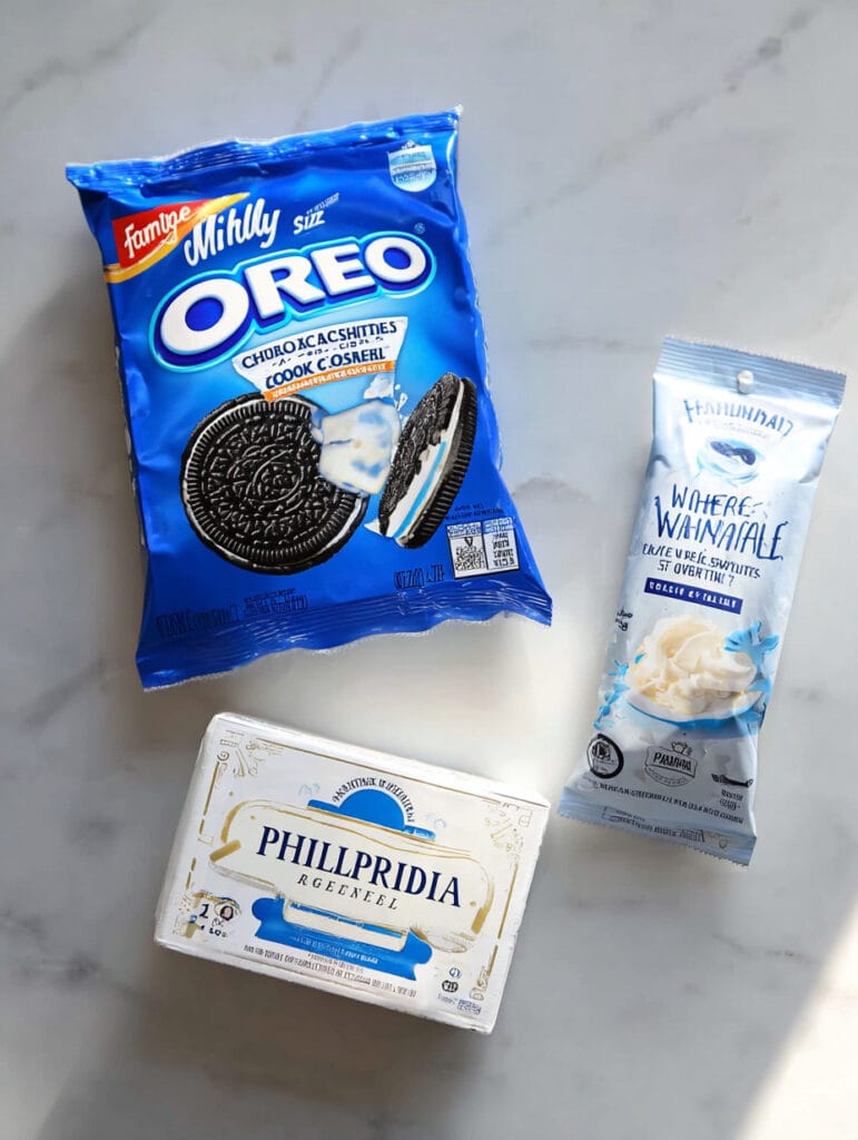 Three product packages - Oreo cookies, Philadelphia cream cheese, and Ghirardelli white melting wafers - arranged on a light marble surface.